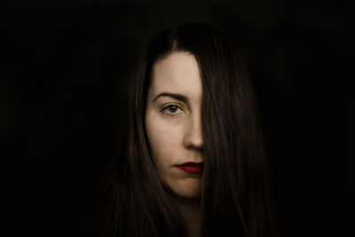 Close-up portrait of a serious women with red lipstick