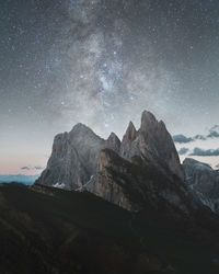 Scenic view of mountains against sky at night