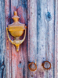 Old textured wooden door with knocker