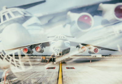 Airplane on airport runway against sky