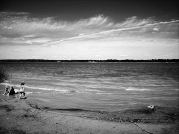 Scenic view of sea against cloudy sky