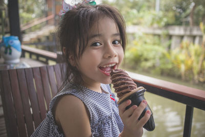 Portrait of happy girl holding ice cream