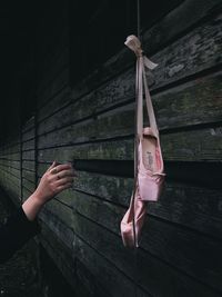 Midsection of woman holding umbrella hanging on wall