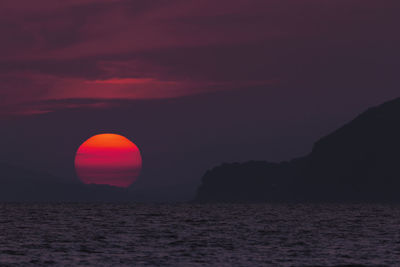 Scenic view of sea against romantic sky at sunset