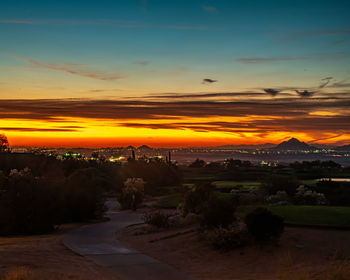 Scenic view of landscape against romantic sky at sunset