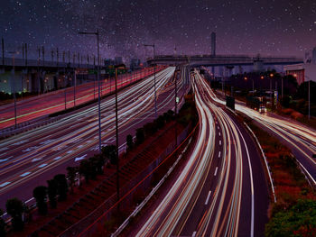 High angle view of light trails on highway at night