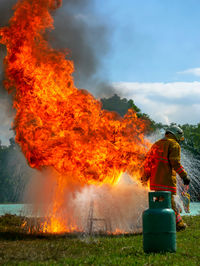 Rear view of man walking by fire