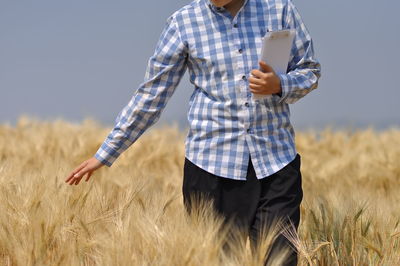 Midsection of man standing on field