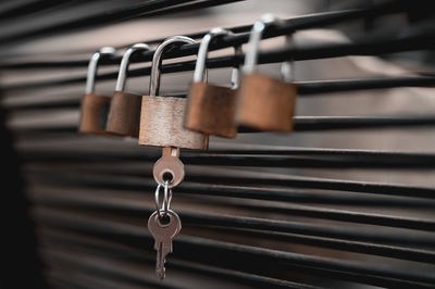 Close-up of padlocks on railing