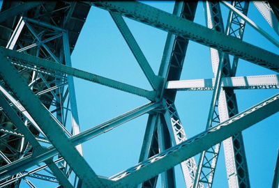 Low angle view of bridge against blue sky