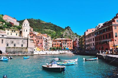Boats in river with buildings in background