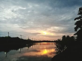 Scenic view of lake against sky during sunset