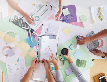 High angle view of business colleagues working on table