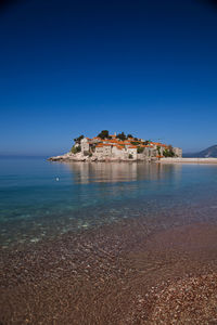 Scenic view of sea against clear blue sky