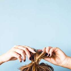 Close-up of woman hand over white background