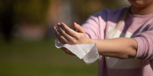 Midsection of woman holding purple leaf