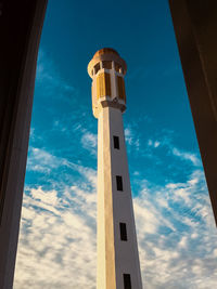 Low angle view of tower and building against sky