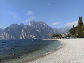 Scenic view of sea and mountains against sky