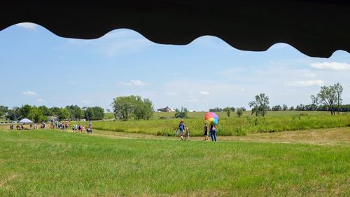 People on field against sky