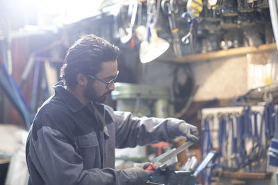 Young plumber technician working in workshop