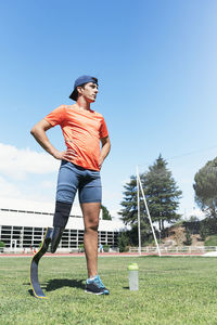 Full length of man standing on grass against sky