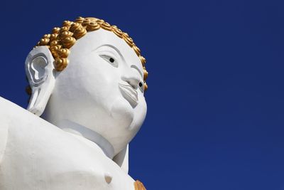 Low angle view of statue against clear blue sky