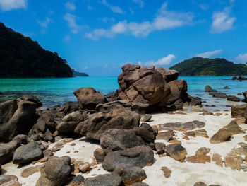 Rocks on beach against sky