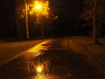 View of illuminated road at night during winter