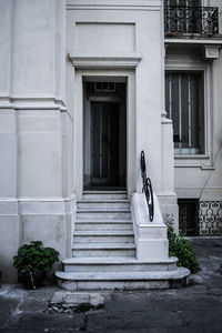 Low angle view of potted plant against old building