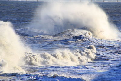 Waves breaking against sea