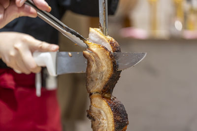 Cropped hand of man preparing food