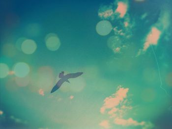 Low angle view of airplane flying against blue sky