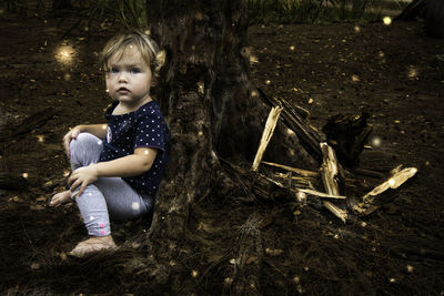 Portrait of boy sitting at night