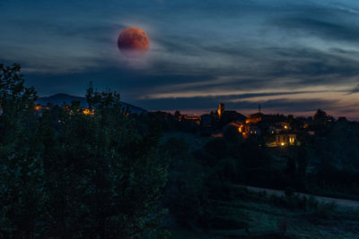 Scenic view of buildings against sky at night