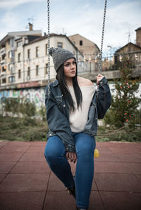 Young woman sitting on swing