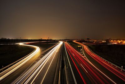 High angle view of light trails on highway at night