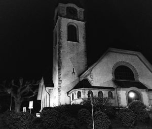 Low angle view of illuminated cathedral against sky at night