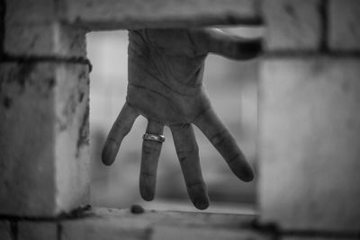 Close-up of hands against wall