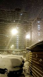 Car on illuminated street during winter at night