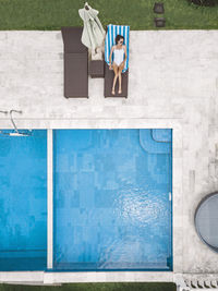 Aerial view of attractive woman near the pool at resort