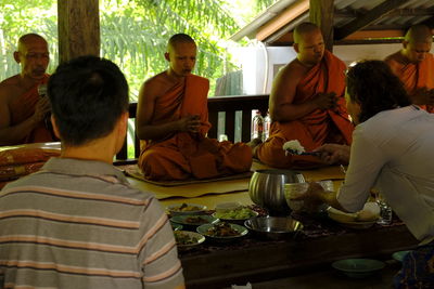 People sitting at market stall