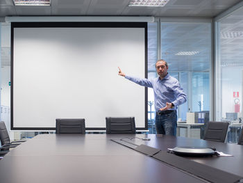 Man working with arms outstretched standing at home