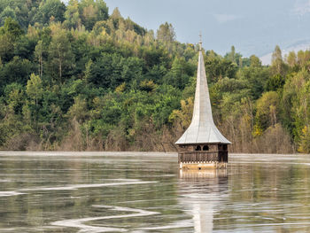 Scenic view of lake in forest against sky