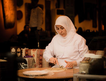 Midsection of woman working at restaurant