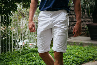 Midsection of man standing by plants