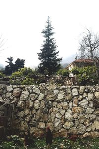 Stone wall against clear sky