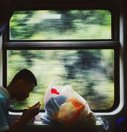 Man looking through glass window