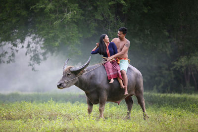 Full length of man riding horse on field