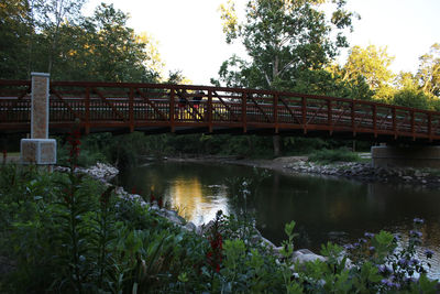 Footbridge over river against sky