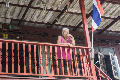 Girl standing by railing